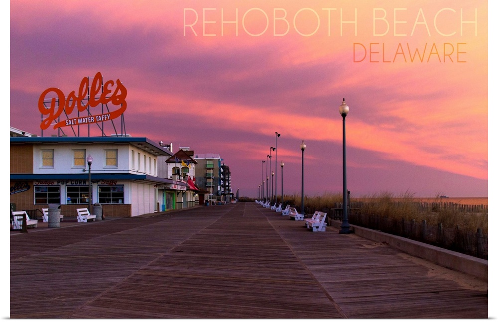 Photograph of Rehoboth Beach, Delaware of the Dolles candy store and vibrant sunset.