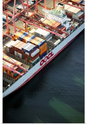 Crane loading cargo onto container ship, Port of Seattle, WA - Aerial Photograph