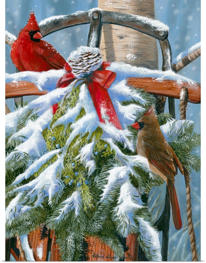 This large artwork piece shows two cardinals standing in a snow covered wreath that covers an old fashioned sled.