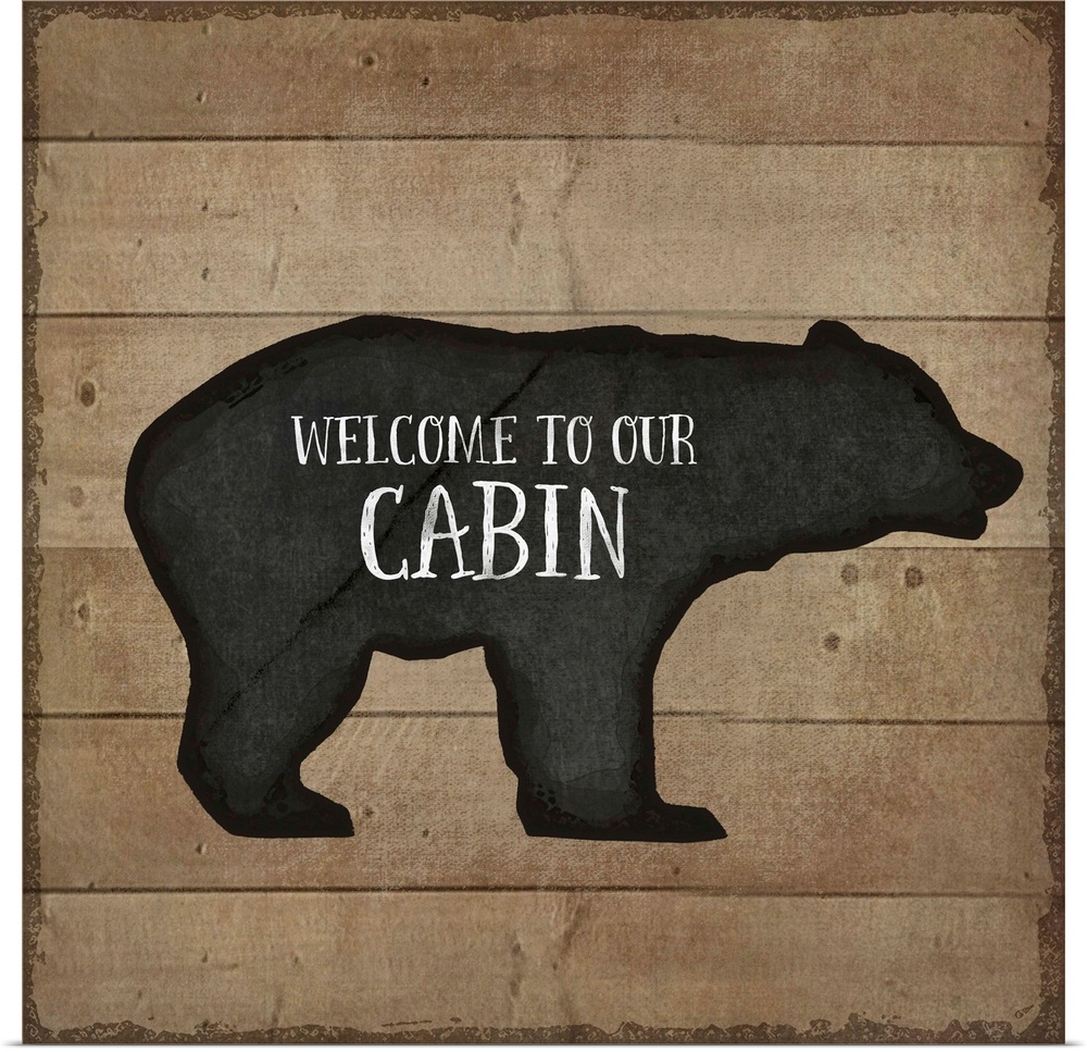 "Welcome to Our Cabin" on a bear silhouette over a wooden background.