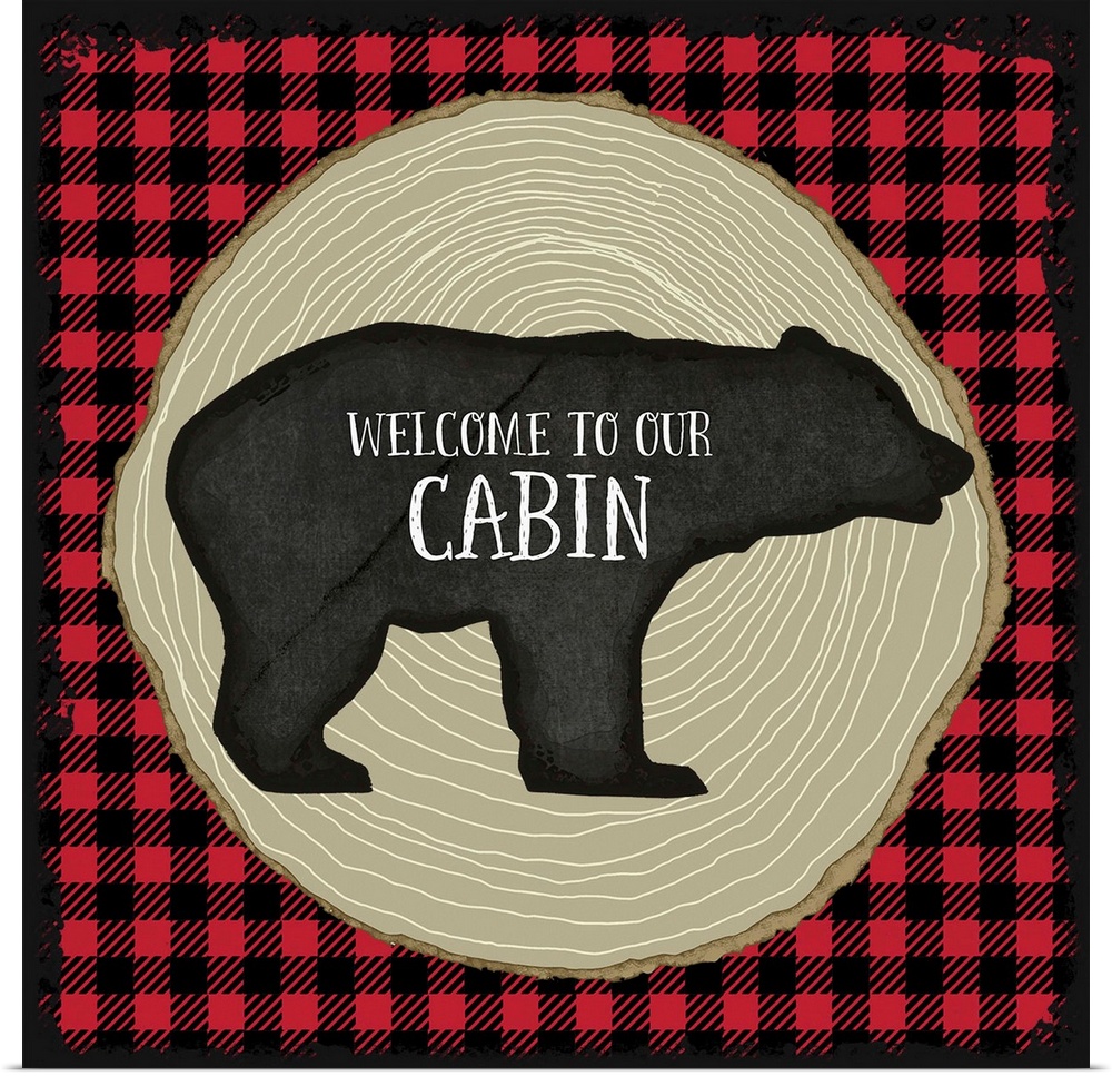 "Welcome to Our Cabin" on a bear silhouette over red and black plaid and tree rings.