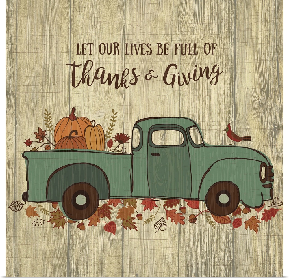Thanksgiving themed decor of a blue truck carrying pumpkins on a leafy trail.