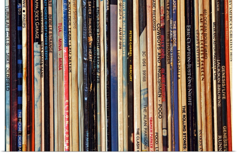 Big photograph shows a large collection of LP vinyl records that includes works from artists such as Eric Clapton, Billy J...