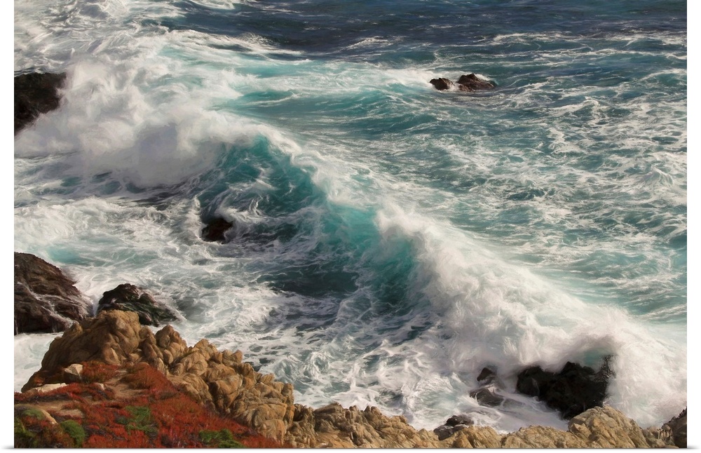 Gorgeous teals and blues are set in motion by a crashing wave in Big Sur, contrasting with the reds and browns of the rock...