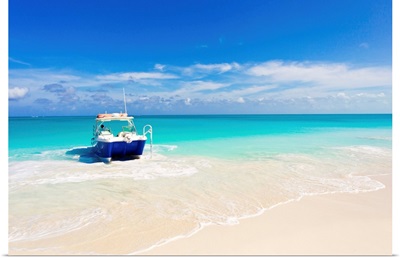 A boat pulled up onto a beach on a private island in the Turks and Caicos Islands