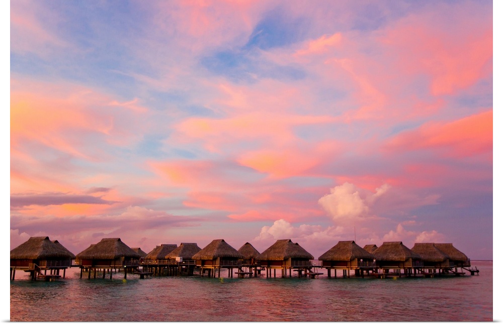 Incredible sunset over the bungalows of Mo'orea in the French Polynesian islands.