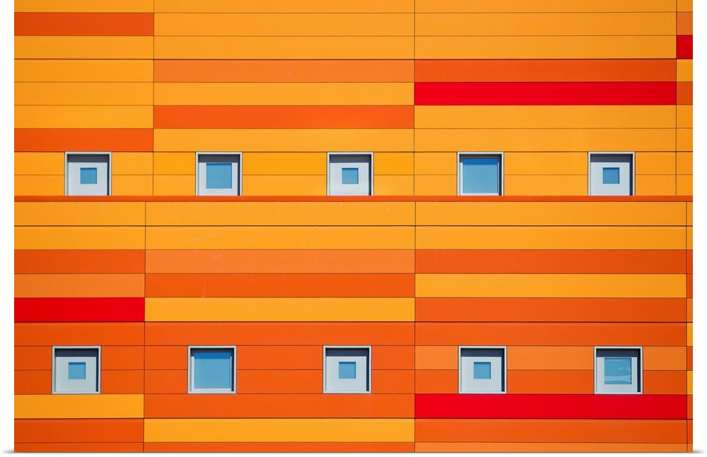 An modern building decorated with bright orange stripes.