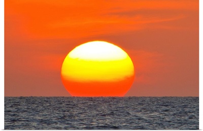 Close up of the sun setting over the Gulf of Mexico