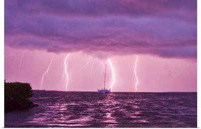 Lightning bolts striking the ocean, and almost hitting a sailboat