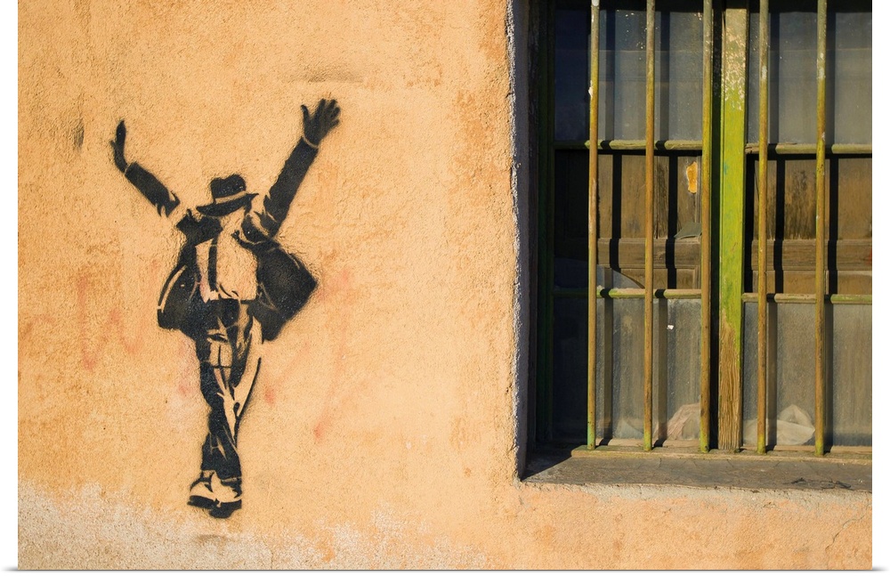 Michael Jackson stenciled on a wall near a window.