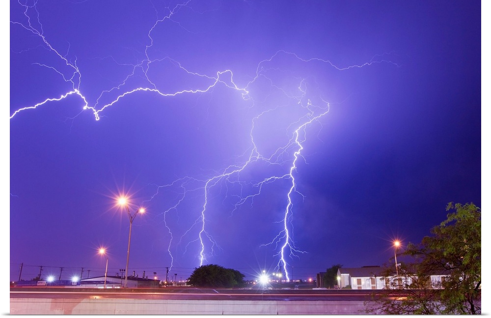 Multiple lightning bolts stike from an intense lightning thunderstorm.