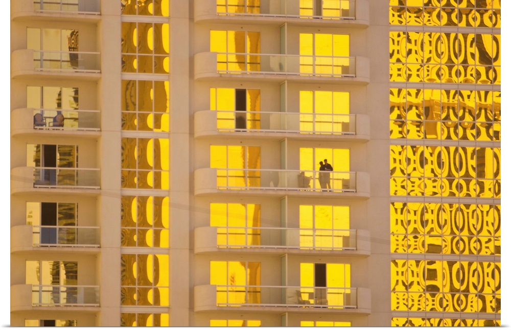 Sunlight reflects bright gold on high rise casino windows.