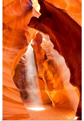 Sunlight streams through cracks in a slot canyon