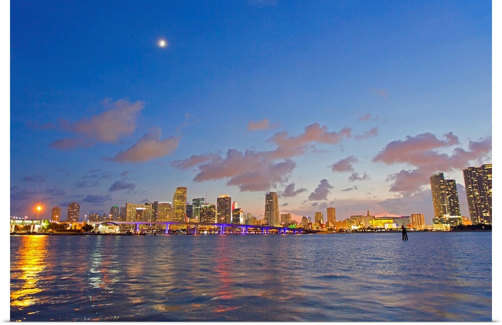 The full moon over Miami's skyline at dusk.