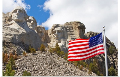The United States flag proudly flying in front of Mount Rushmore