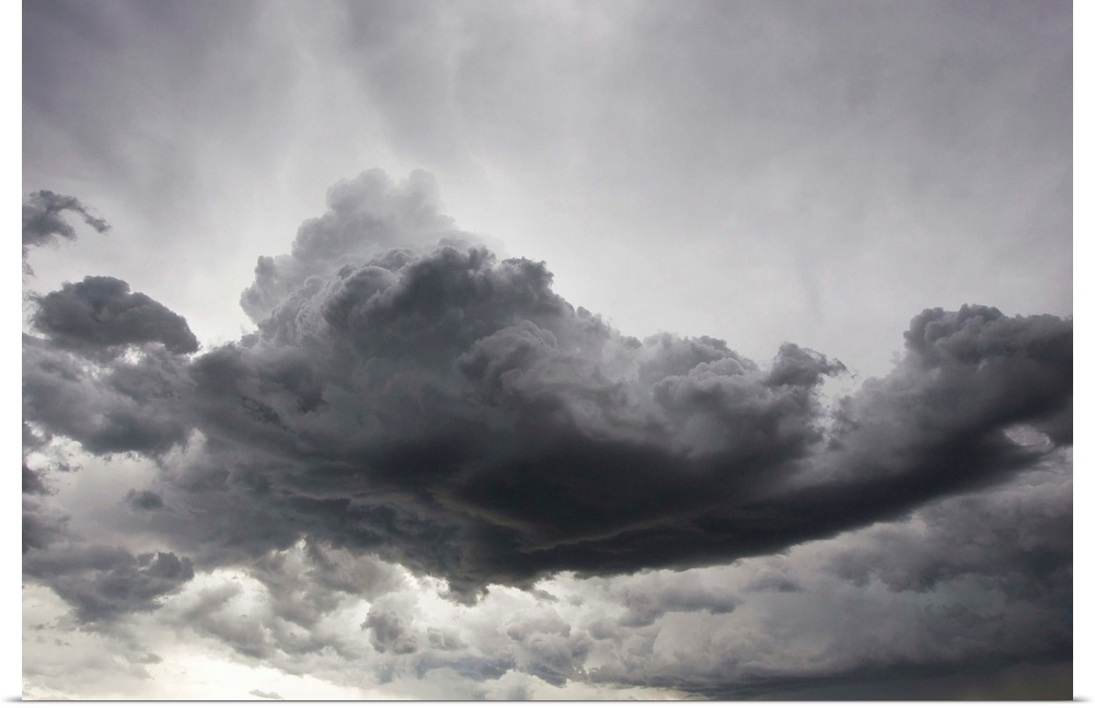 Underneath a supercell thunderstorm with dark and eerie storm clouds.