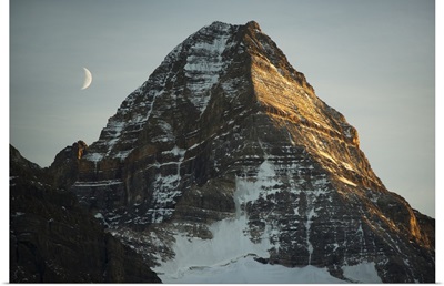 Crescent moon and summit of Mount Assiniboine, British Columbia, Canada