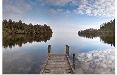 Dock in Lake Mapourika with mist rising off water, Westland National Park, New Zealand