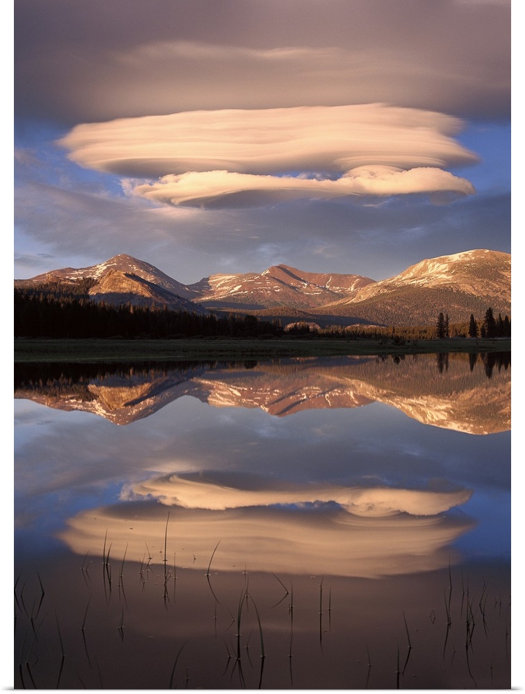 Tall canvas photo art of billowing clouds above rolling hills reflected in the water.
