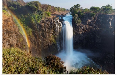 Rainbow formed in mist from waterfall, Victoria Falls, Zimbabwe