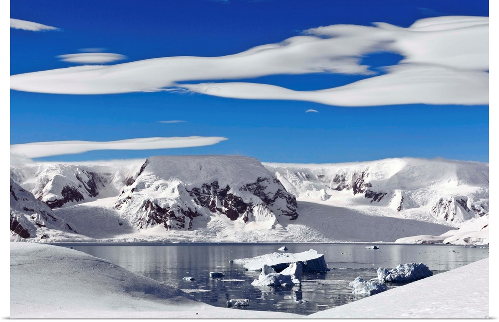 Snow-covered mountains along coast, Antarctica.