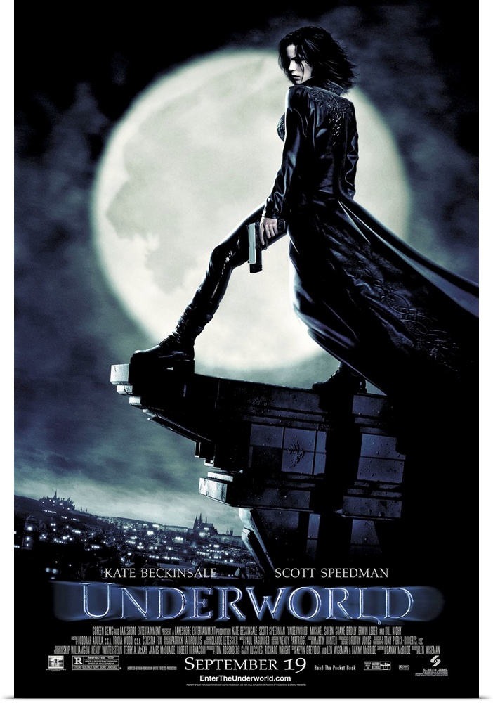 Large, vertical movie advertisement for Underworld, main character Selene stands with a gun in her hand, on the edge of th...