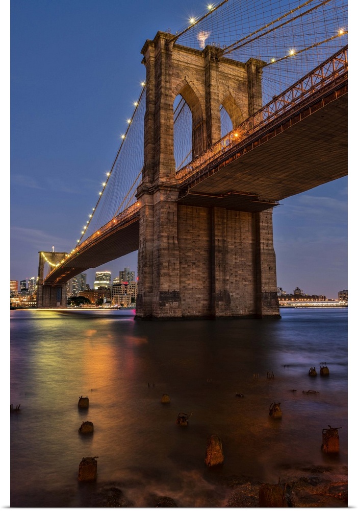 A photograph of the Brooklyn bridge at twilight.