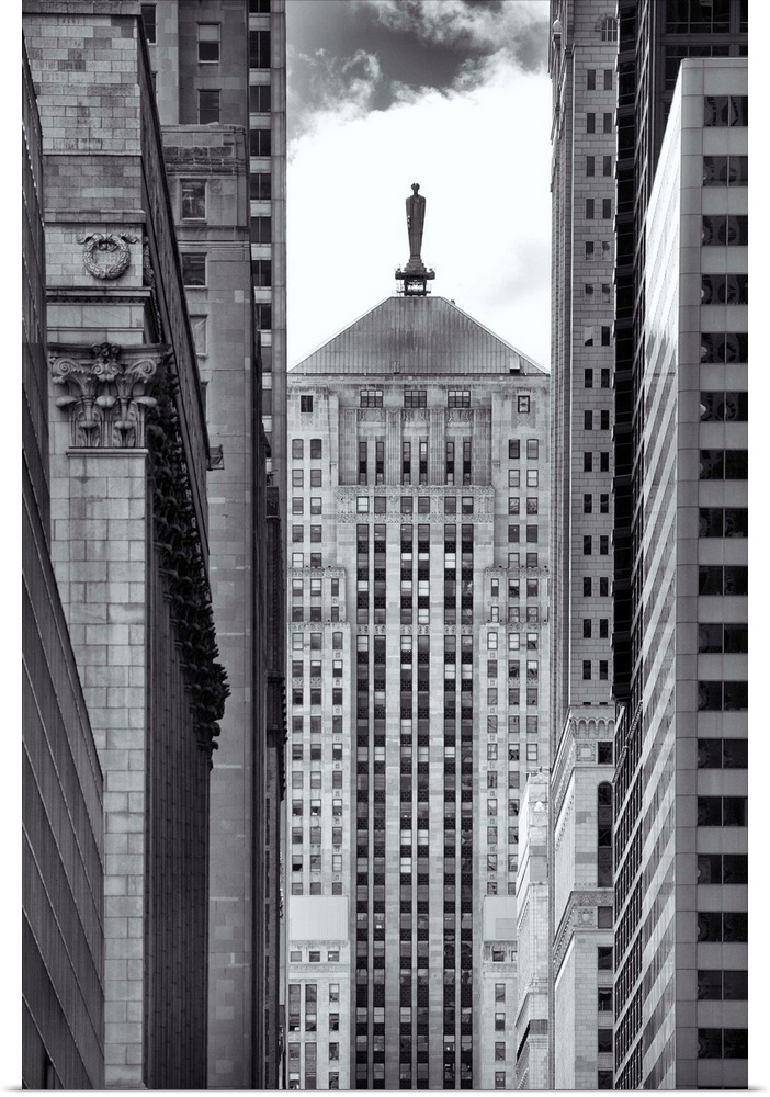 Black and white photograph through a narrow way through tall buildings in Chicago.