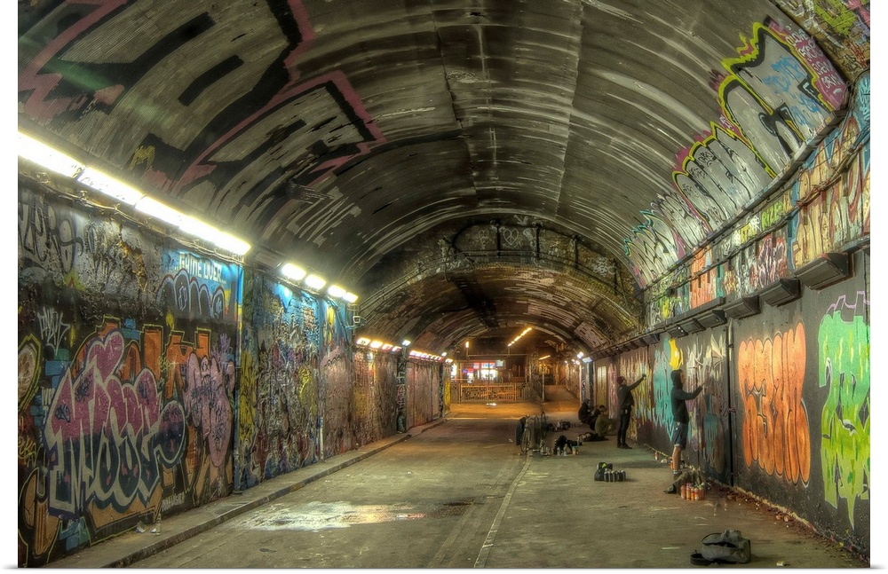 HDR photograph of a tunnel with its walls filled with graffiti.