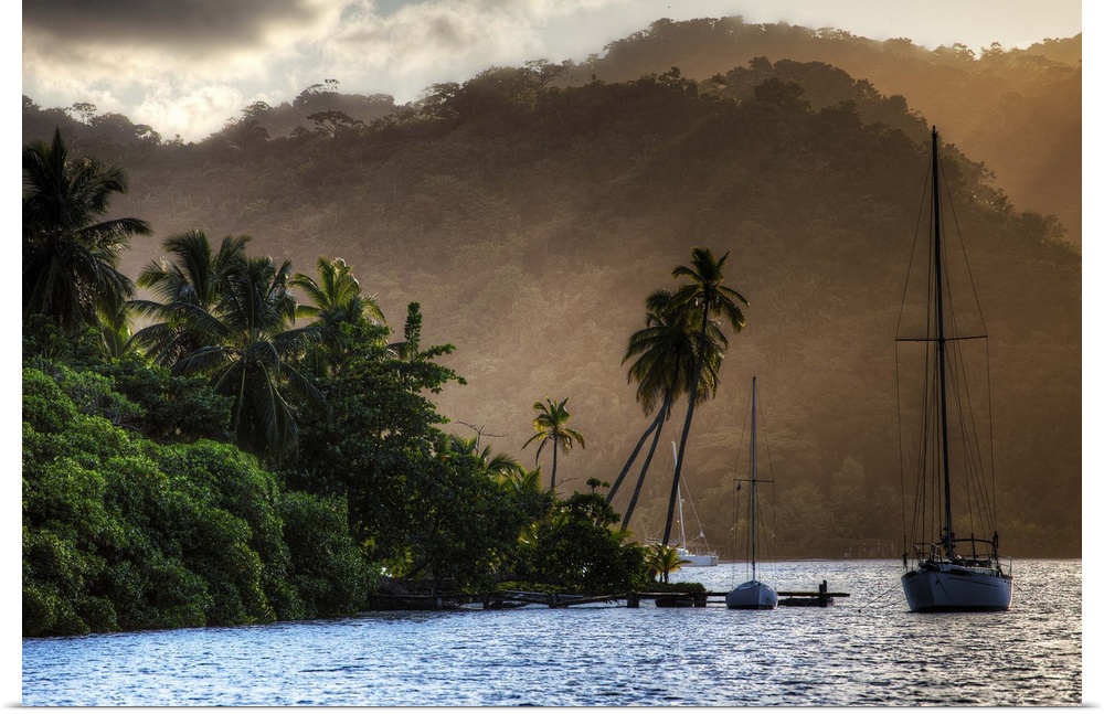 A photograph of a tropical destination with a silhouetted sailboat in the distance.