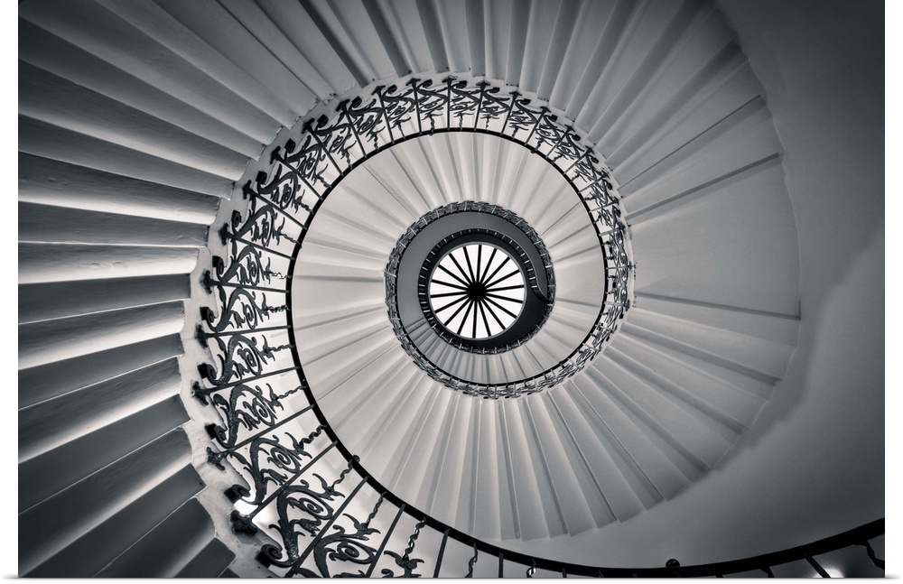 Photograph looking up at a spiral staircase.