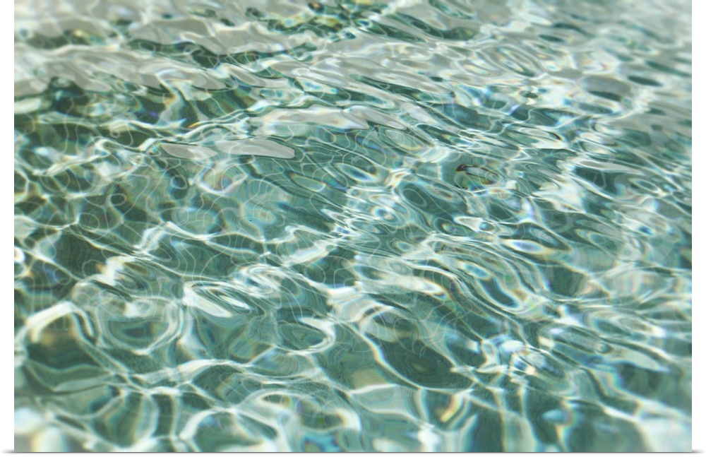 Abstract image of light forming patterns on rippling water.