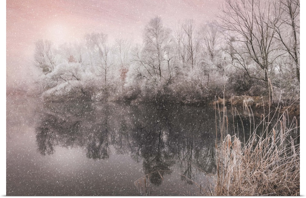 Magenta toned dreamy photograph of snowfall over a calm lake surrounded by winter trees.