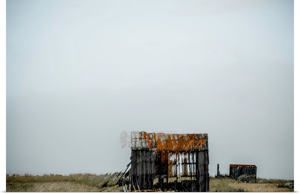 Conceptual photograph of abandoned shacks in the middle of no where with a clear sky full of negative space.