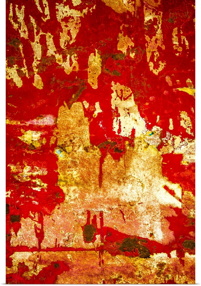 Close up of graffiti on a wall, creating an abstract image in red and gold.