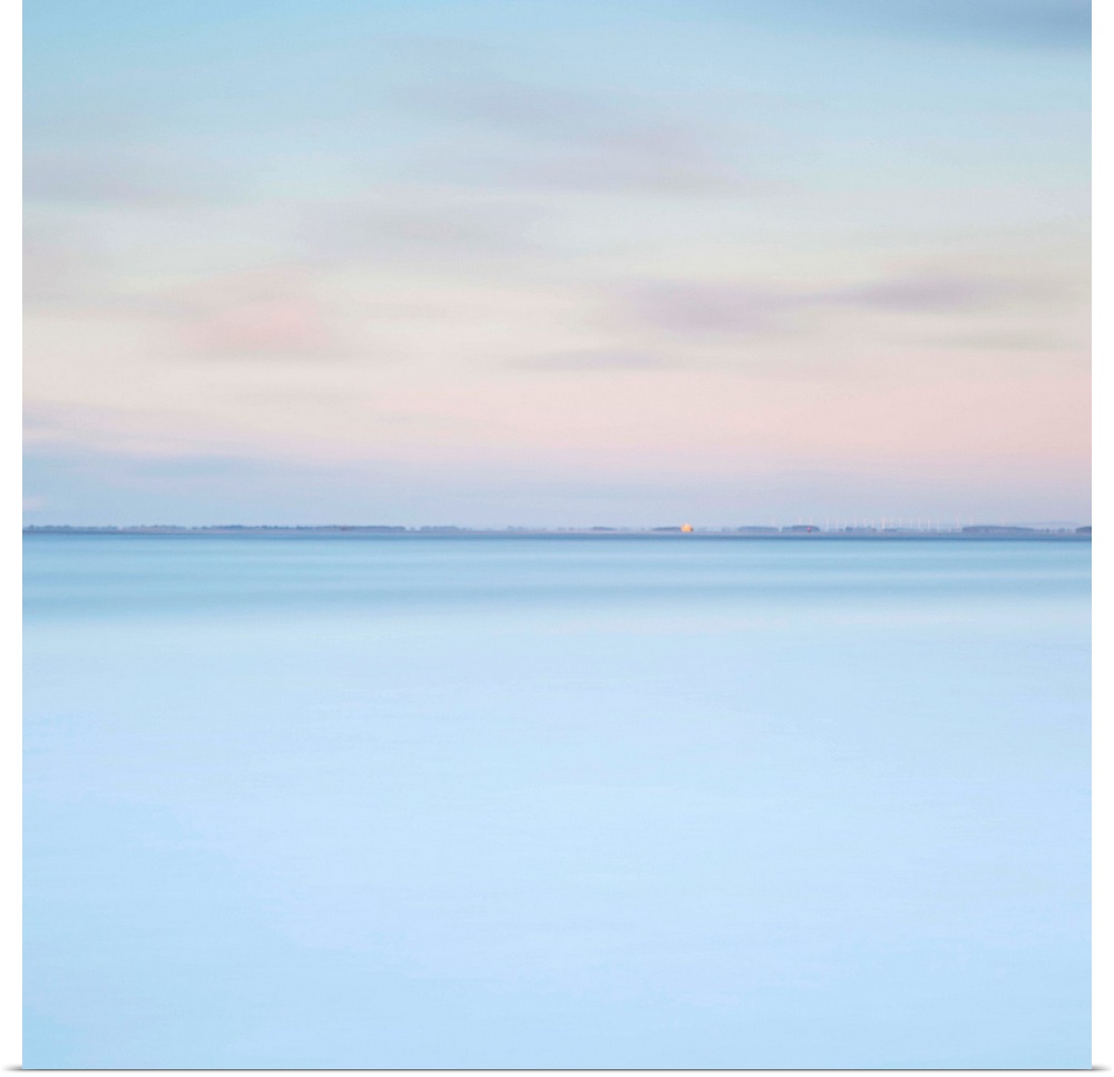 A zen minimalist blue and pink dawn over water with just a distant horizon line and layers of pure colour.
