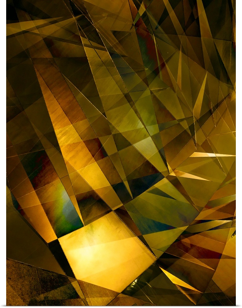 Abstract photograph made of intersecting angles and lines in varying golden shades.