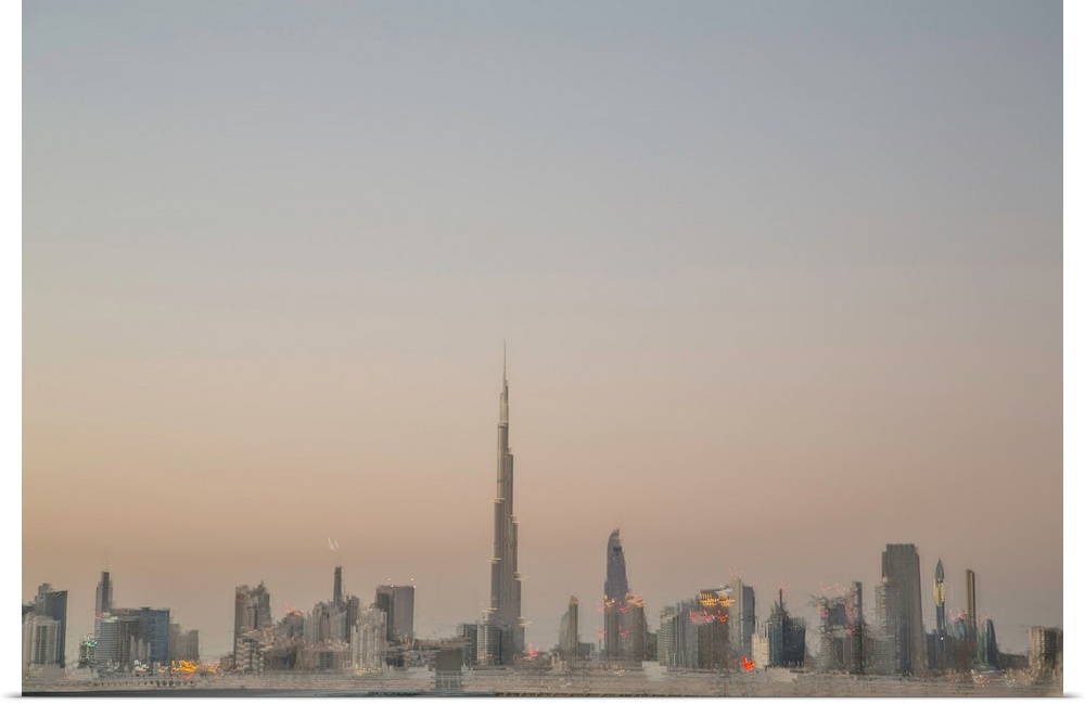 Photograph of a blurred Dubai skyline created with multiple exposures, at dusk.