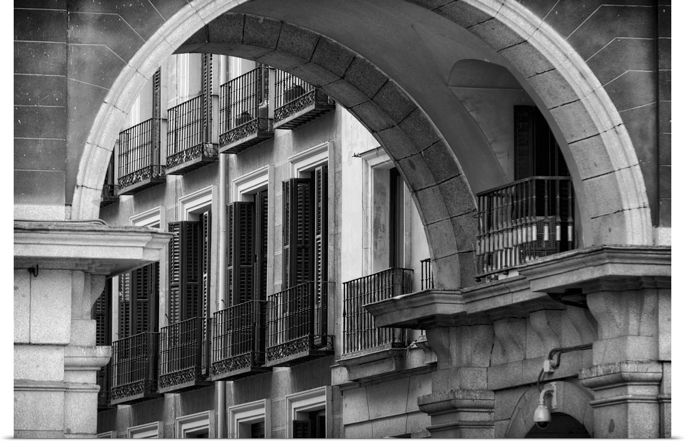 Balconies and Windows with Shutters Viewed through an Arch of Spain