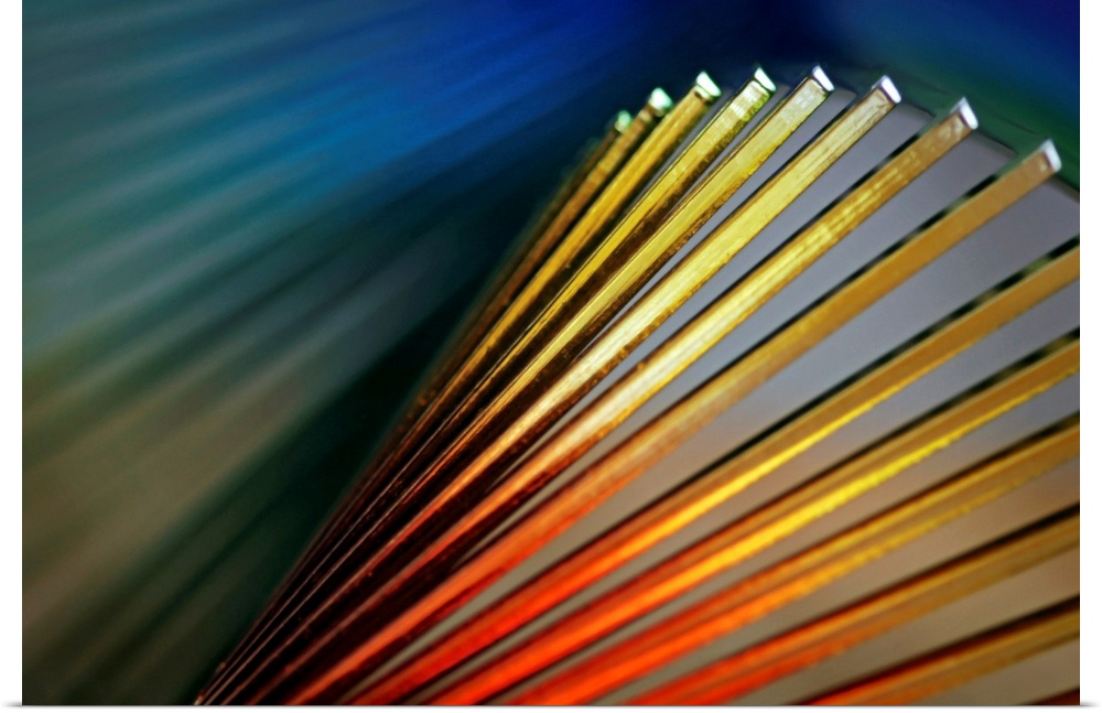 Abstract photo of various colored lines with light shining on them.