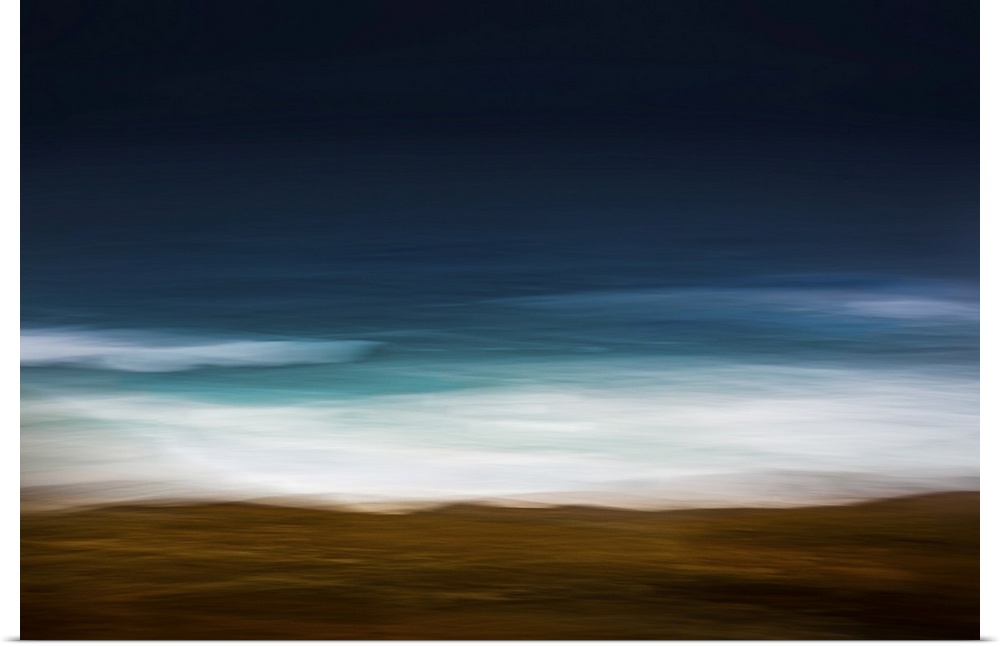 Moody teal and white abstract image of the waves breaking on the shore with fall leaves.