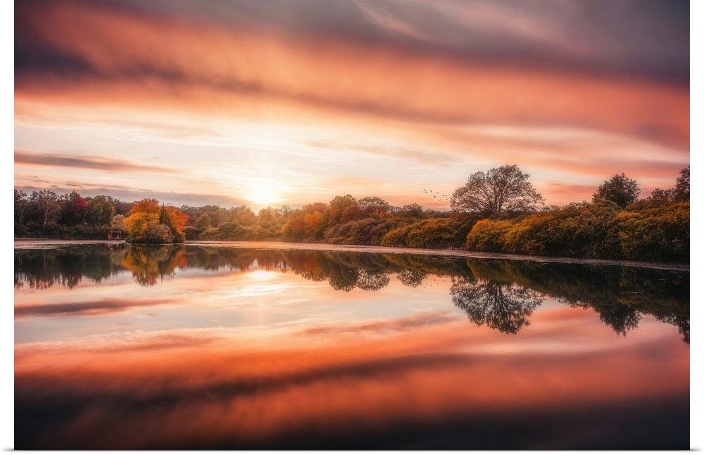 Sunset over a lake in autumn with a beautiful reflection
