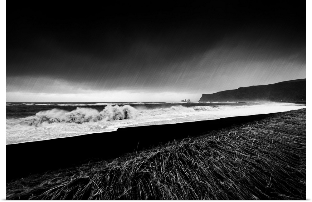 A black and white photograph of a coastal landscape.