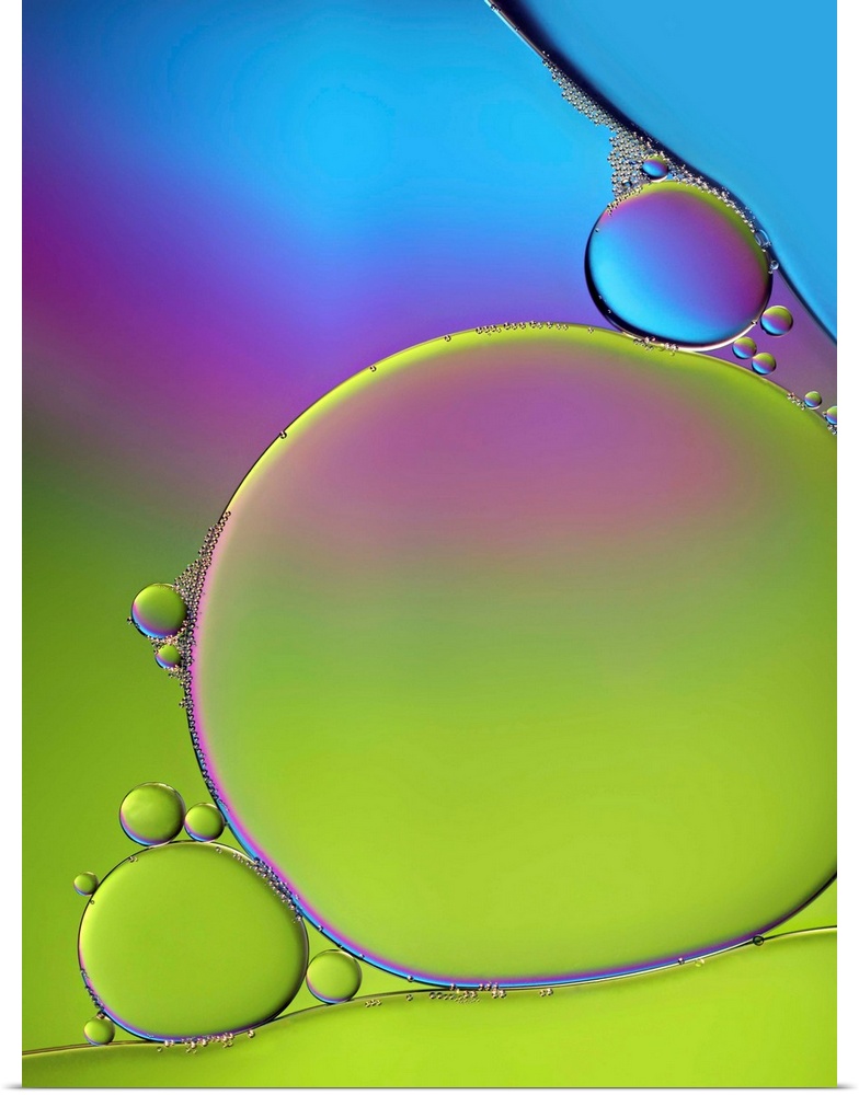 A macro photograph of air bubbles illuminated by vibrant colors.