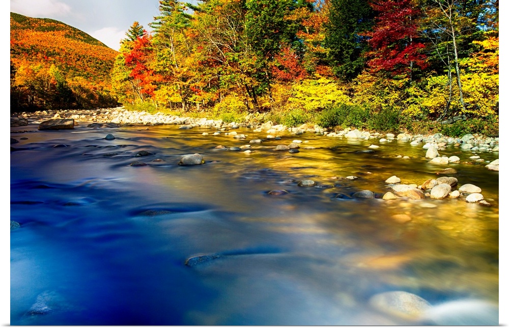 Fine art photo of a clear river near a forest in the fall in New England.