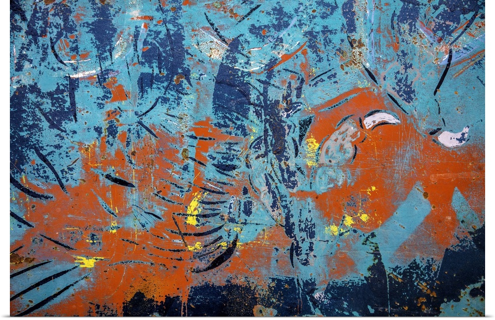 Close up of graffiti on a wall, creating an abstract image in turquoise and orange.