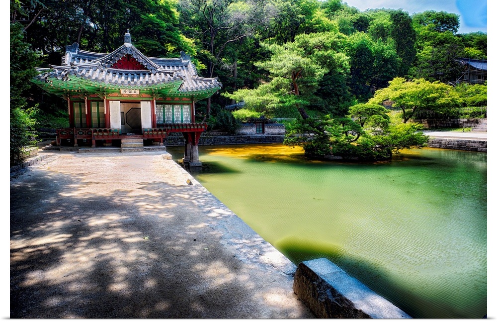 Fine art photo of a pond and small building in a garden in South Korea.
