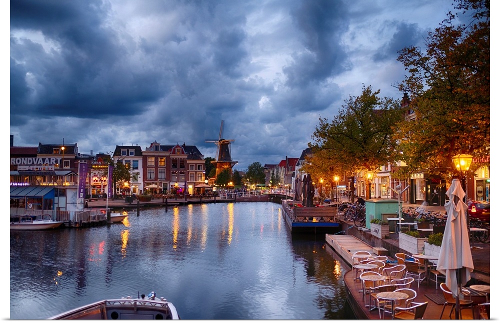 Canal and windmill in Leiden at night, Netherlands.