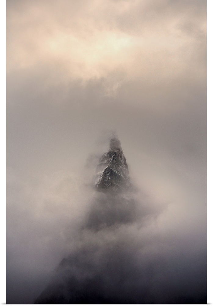 Mountain top, Aiguille des Dru, in the fog in the valley of Chamonix in French Alpes.