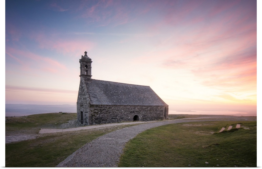 Photograph of a gravel path leading to Chapelle Saint Michel De Brasparts in France at sunset.